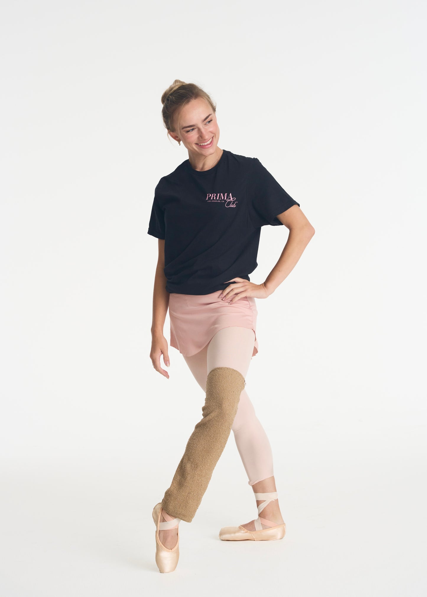 model smiling while wearing black Prima Club t-shirt