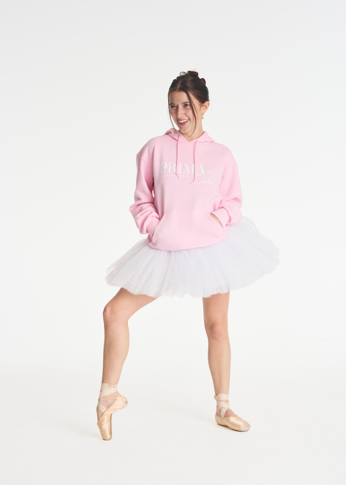 model smiling wearing Pink Prima Club signature hoody