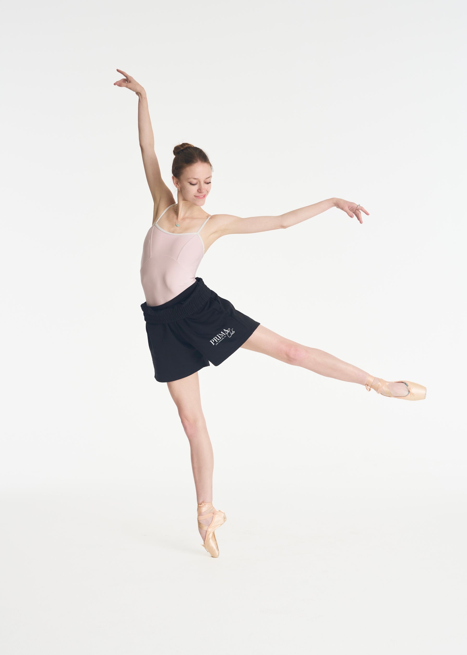 model dancing on pointe wearing The Prima Club shorts