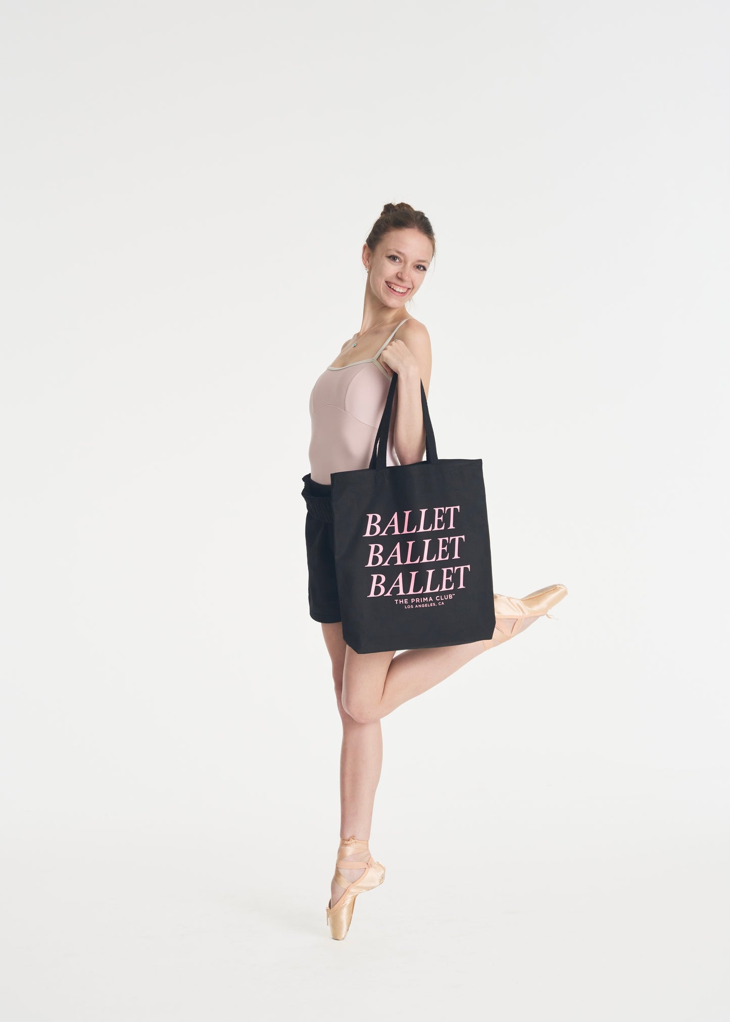 model dancing with black ballet tote bag