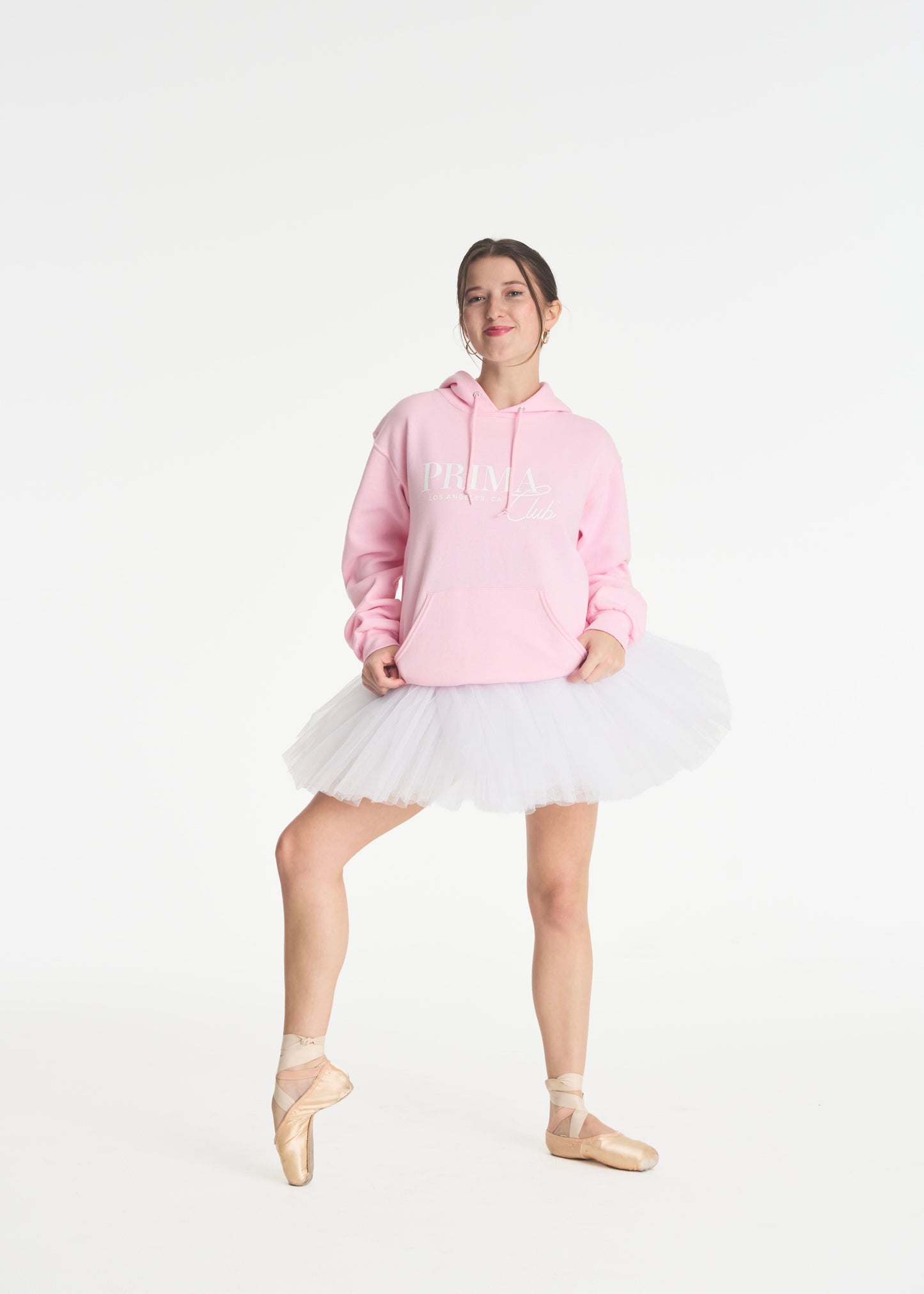 model wearing a tutu and pink Prima Club hoody