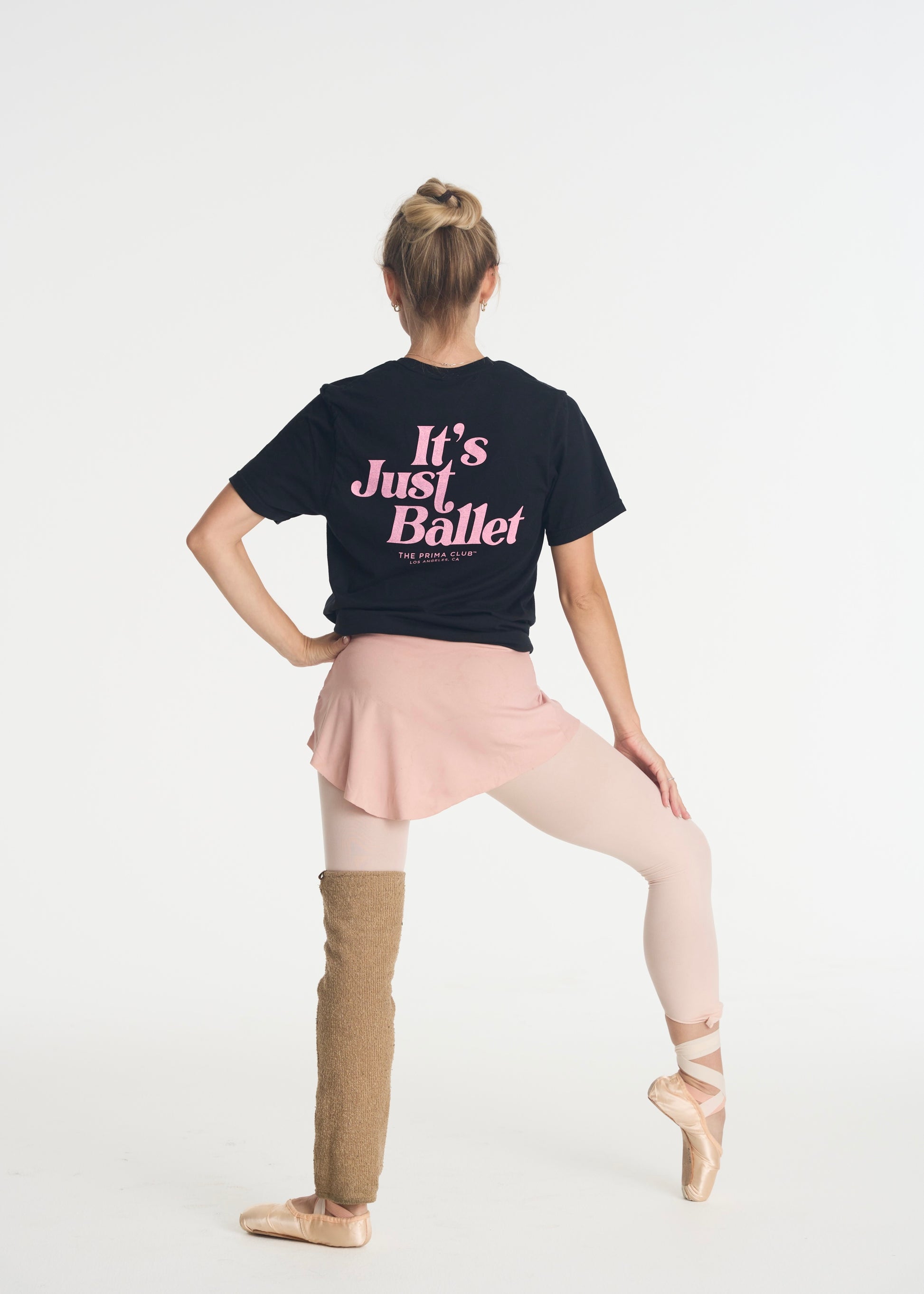 model facing away wearing black t-shirt that says Its Just Ballet.