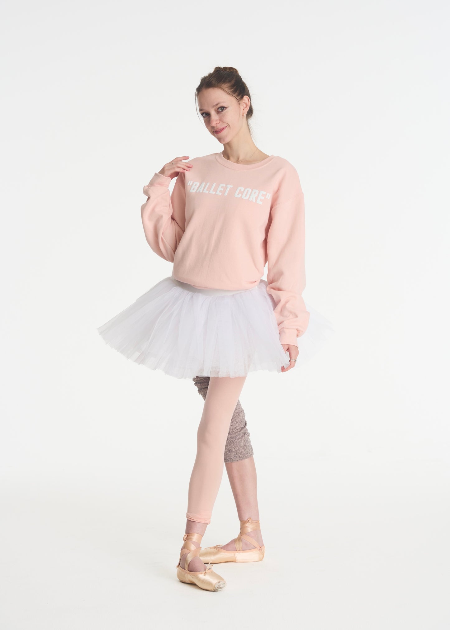 model posing in blush pink ballet core crewneck
